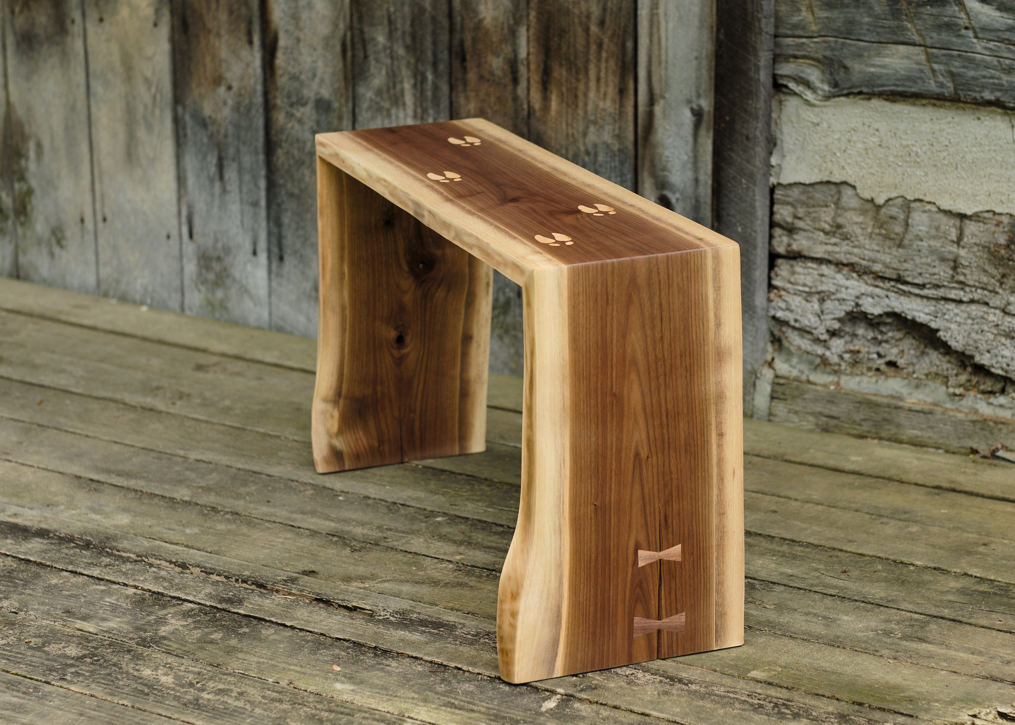 Deer track inlay bench on rustic porch